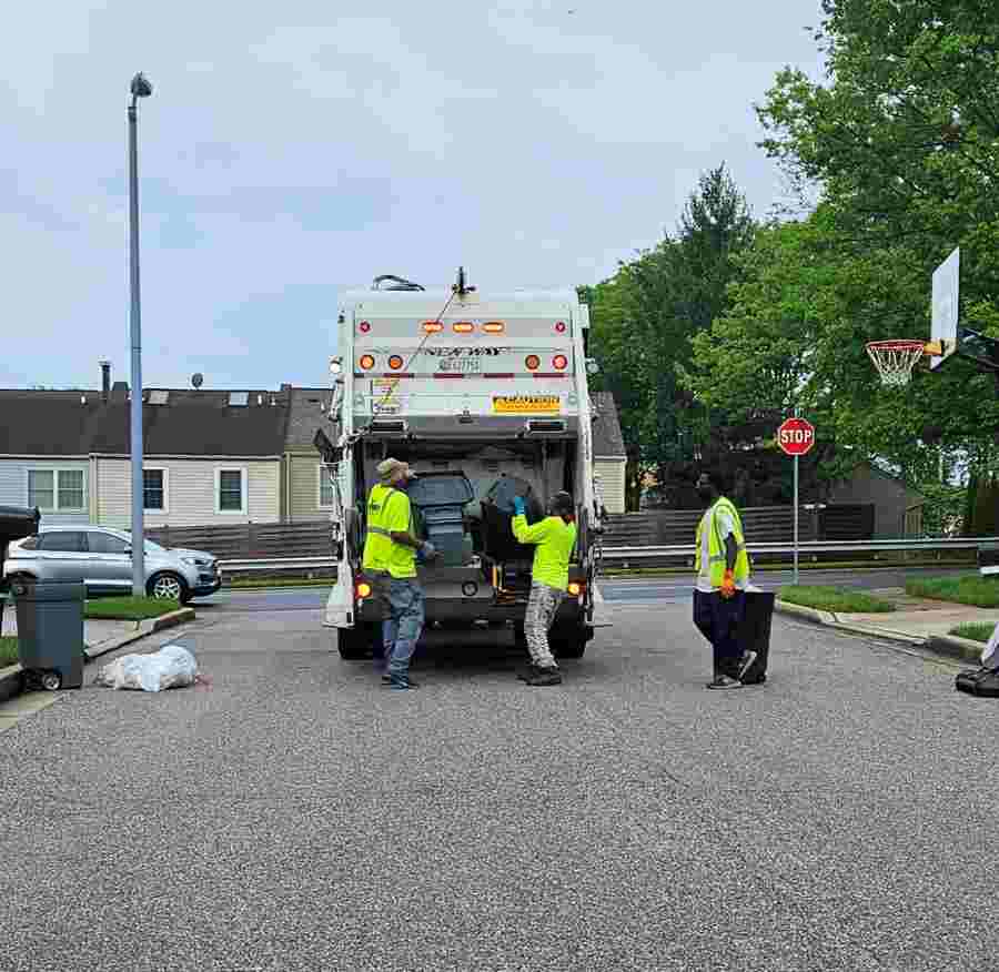 3 people collecting waste from residential