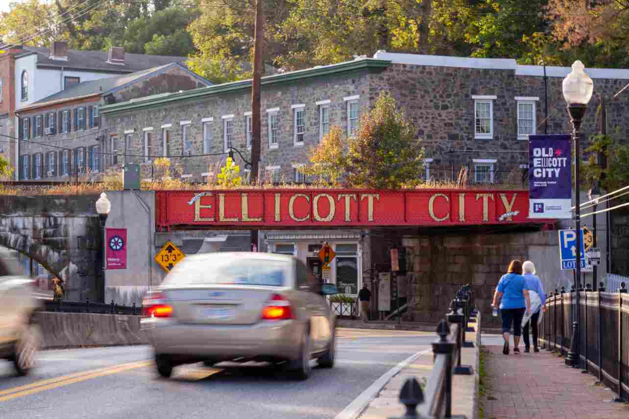 Welcome to Ellicott City sign written in large capital letters on side of the B&O railroad bridge