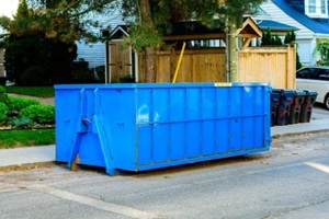 blue roll-off construction dumpster outside a residential renovation project in an older neighourhood
