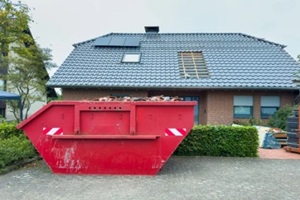 red dumpster outside a home