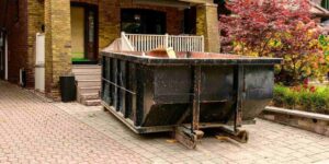 roll-off construction dumpster outside a residential renovation project in an older neighourhood. shot in toronto in the fall
