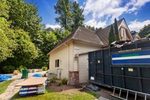 big black dumpster outside a house