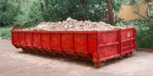 red container with solid domestic and construction waste
