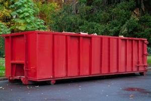 red dumpster on a road