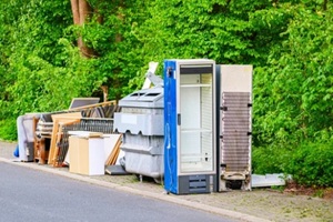 household appliances and furniture piled up for collection on the roadside