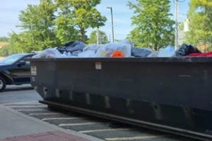large roll off dumpster full of trash metal garbage