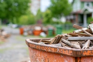 construction dumpster filled with scrap wood in residential neighborhood