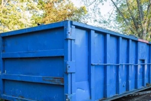 roll-off dumpster filled with building rubble