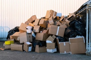 paper boxes next to a garbage bin