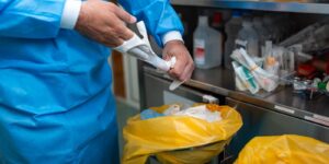medical professional removing sterile surgical gloves after operation