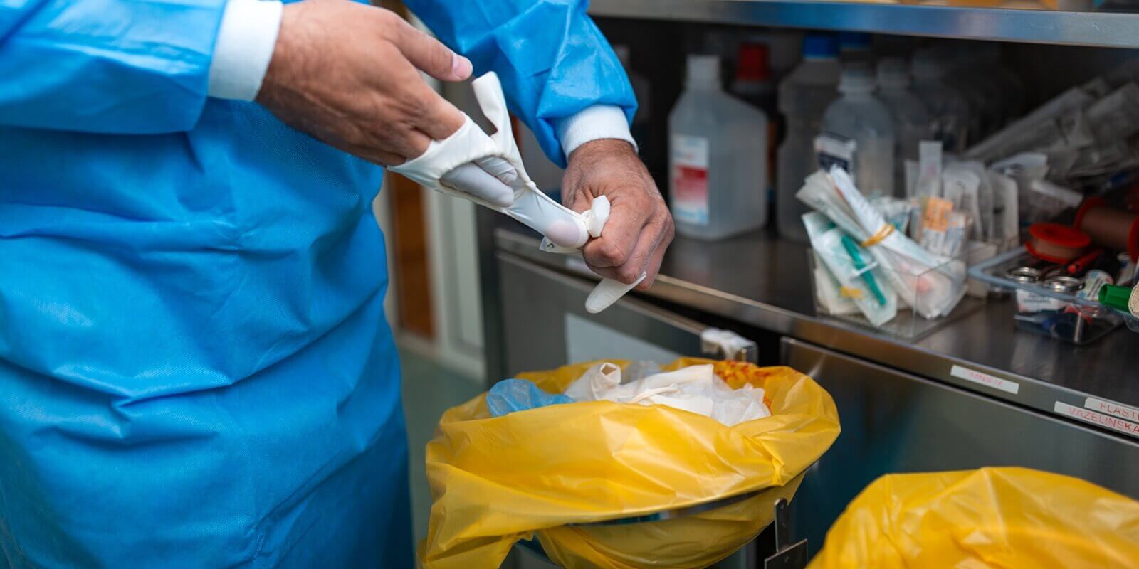 medical professional removing sterile surgical gloves after operation