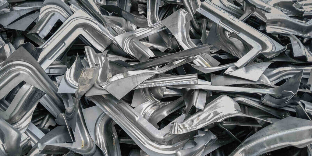 pile of industrial scrap metal pieces from manufacturing press machine process
