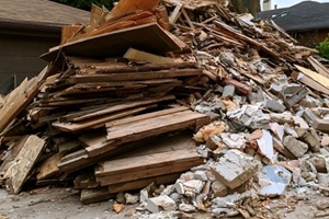 large pile of construction debris and demolition waste in a residential yard
