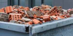 red bricks debris in construction metal waste container close up